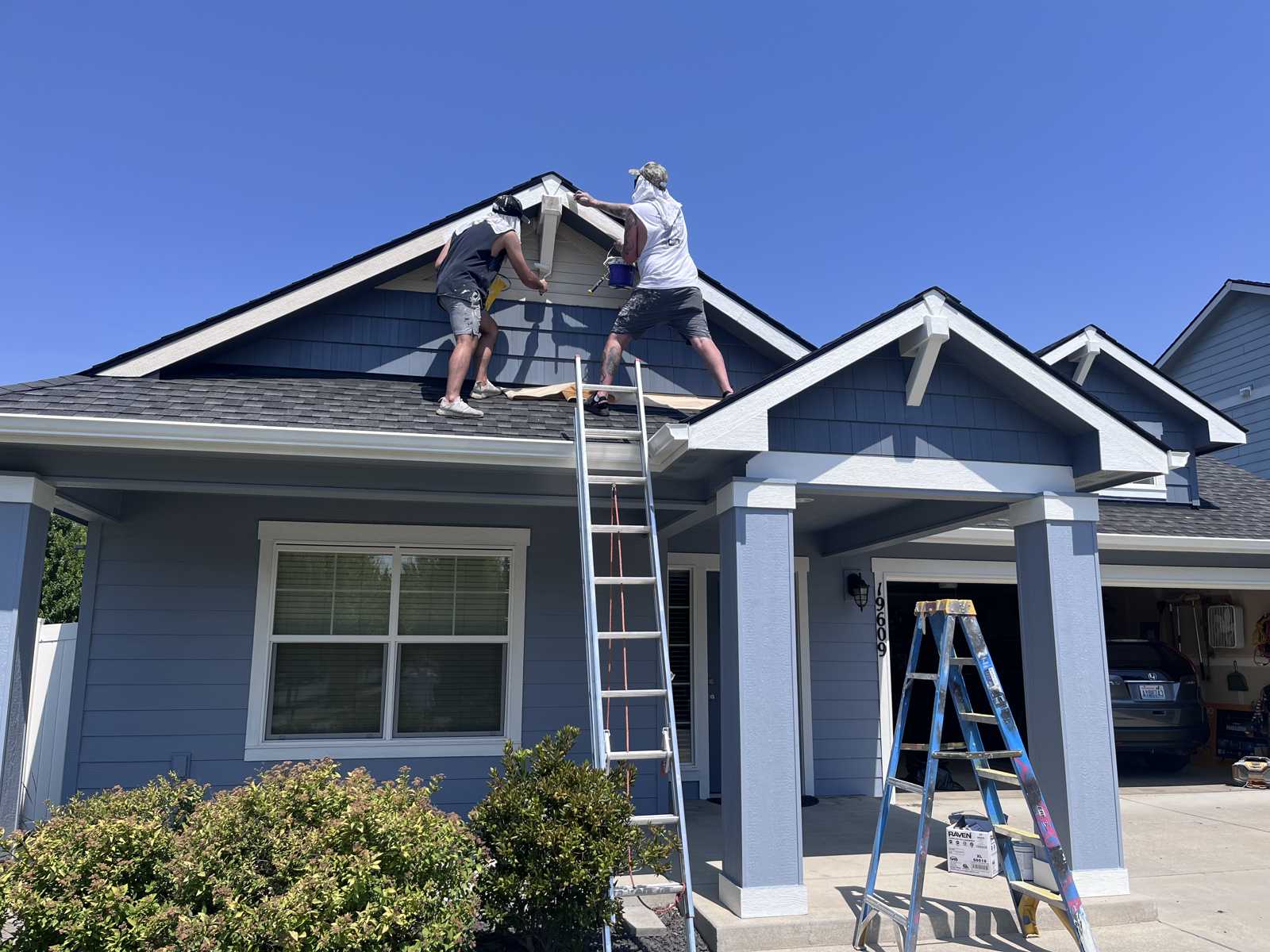 Omni Painting LLC crew on roof trim detail Spokane Valley