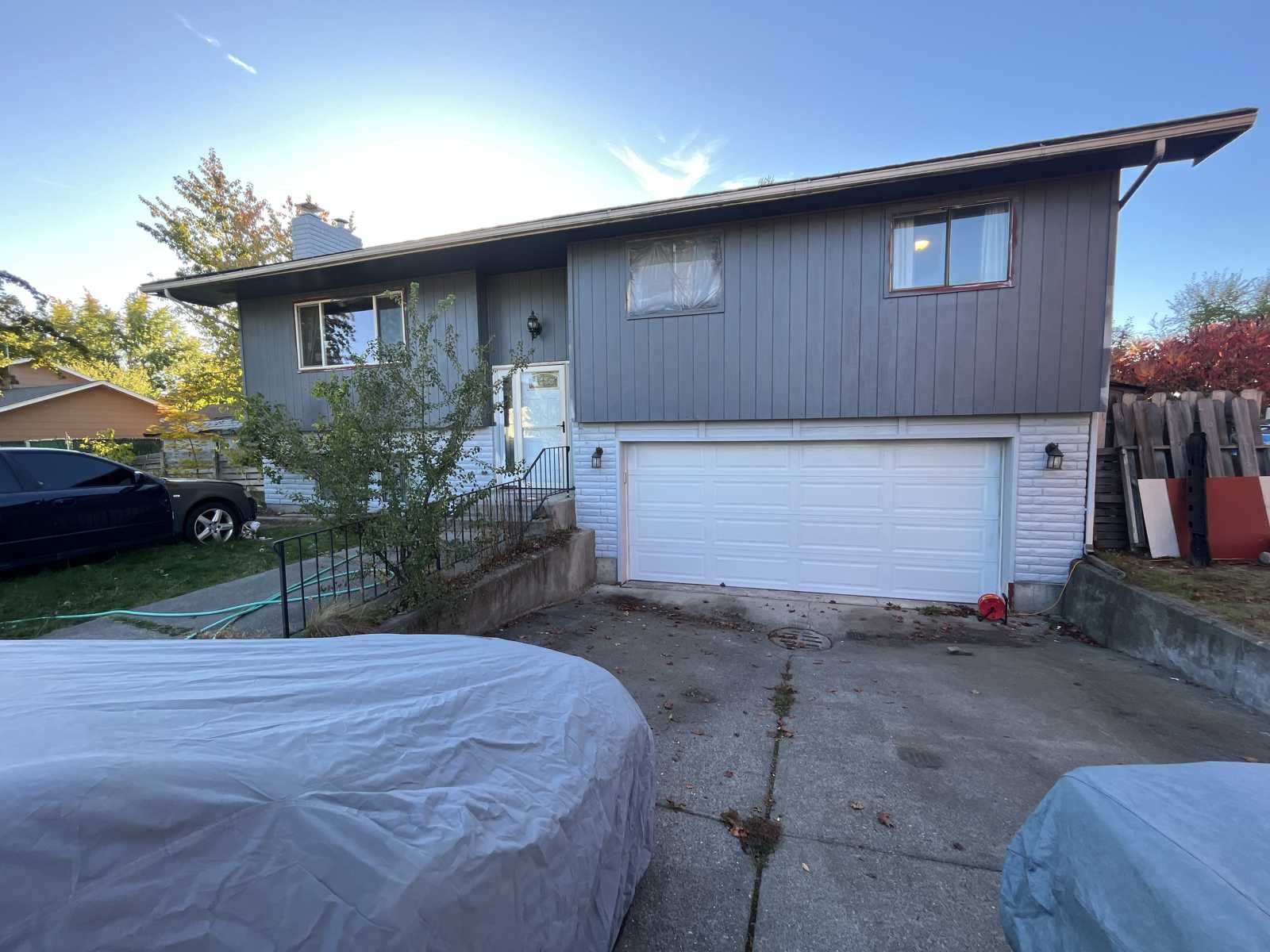 Omni Painting LLC crew spraying porch exterior Spokane WA