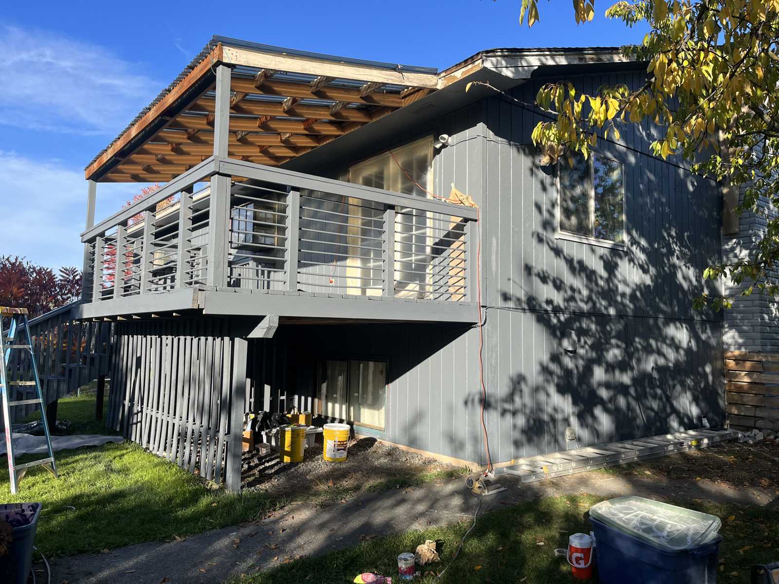 Painter spraying exterior siding Spokane Valley WA