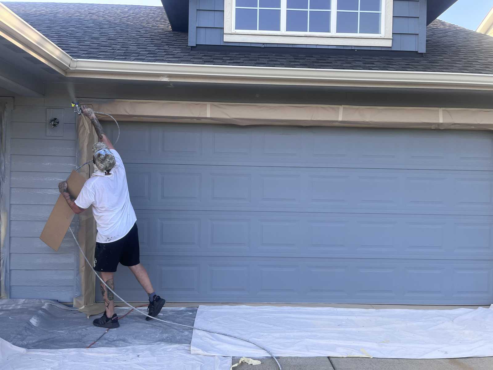Omni Painting LLC Trent spraying garage door exterior Spokane WA
